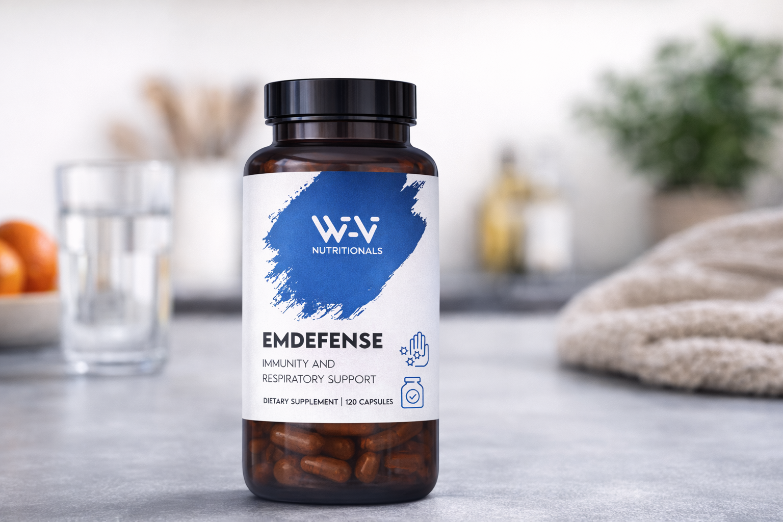 Supplement bottle labeled 'EmDefense' by W-Vi Nutritionals on a blurred kitchen background